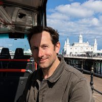Oliver Bennett, Brighton bus tour guide and local sightseeing specialist, on the open-top bus